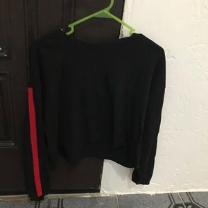 A black long sleeve with red stripes on the sleeve